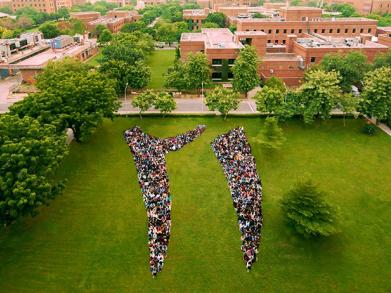 Aerial shot of students forming the digits of 21 in urdu 