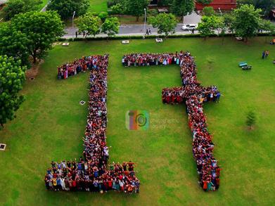 Aerial shot of students forming the digits of 17 in urdu 